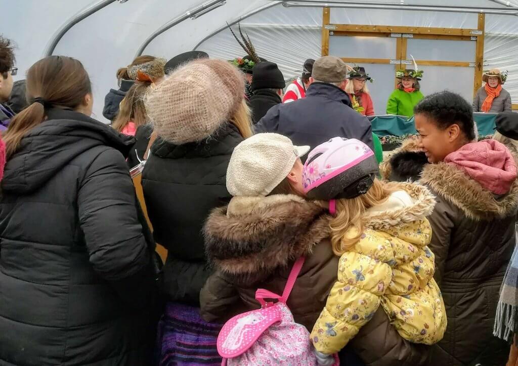 People gathering in the polytunnel